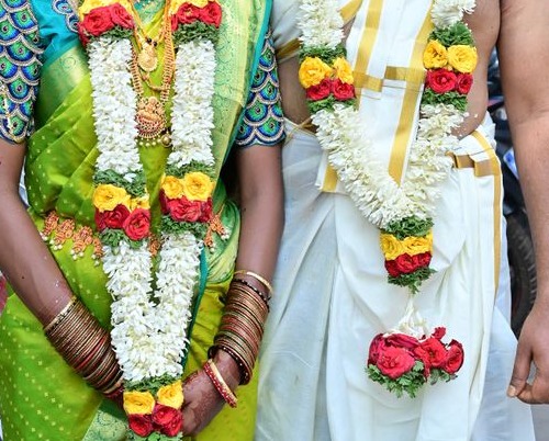 Faceless sample photograph of South Indian wedding garlands and silk clothing