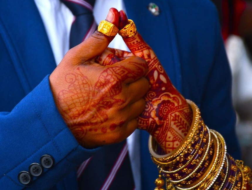 Close-up of wedding hands and jewellery, no faces